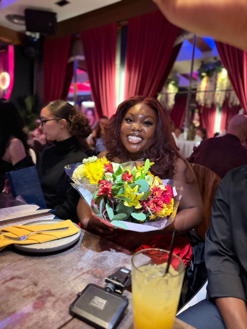 Gizelle beaming with her bouquet