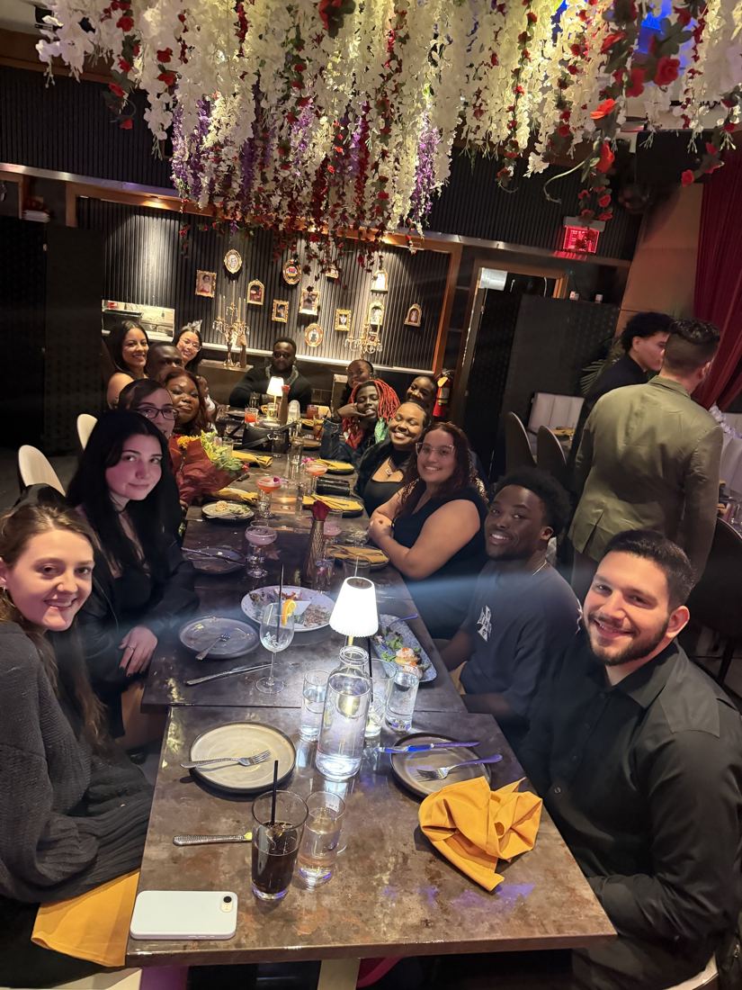 Friends gathered around the long dinner table